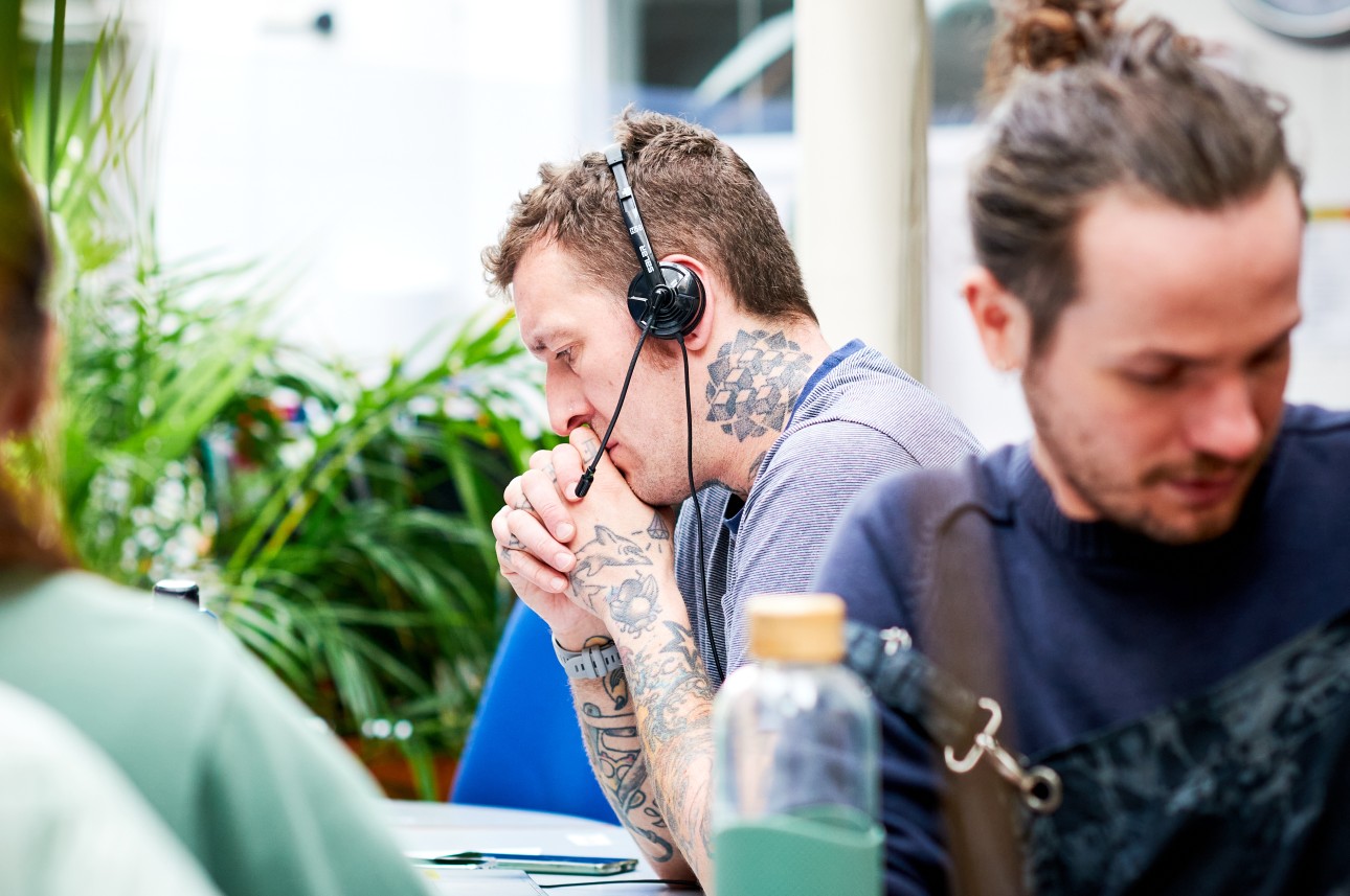 An adviser listening on a headset