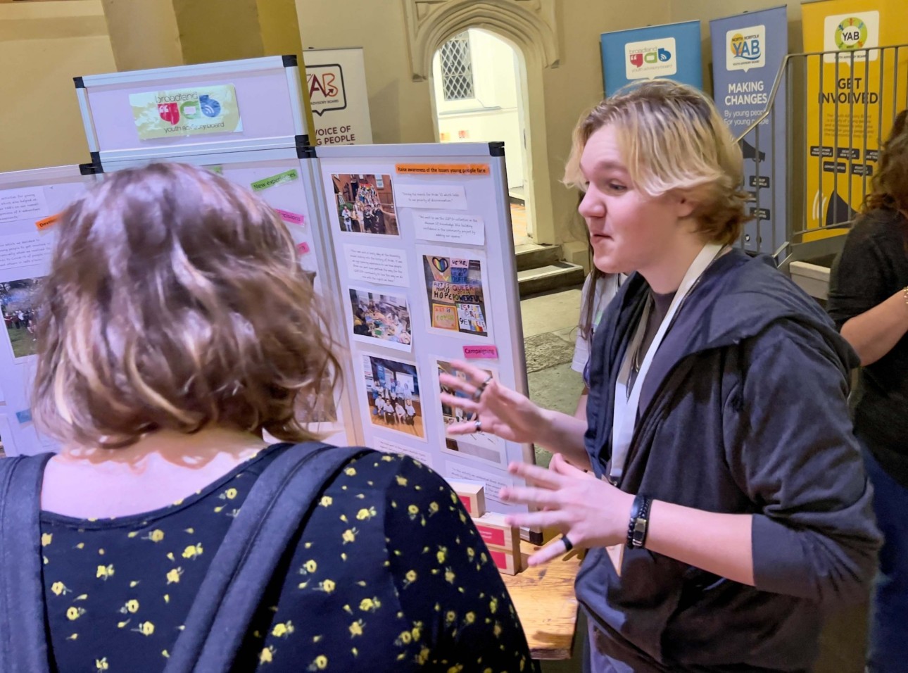 People talking at stall at YAB