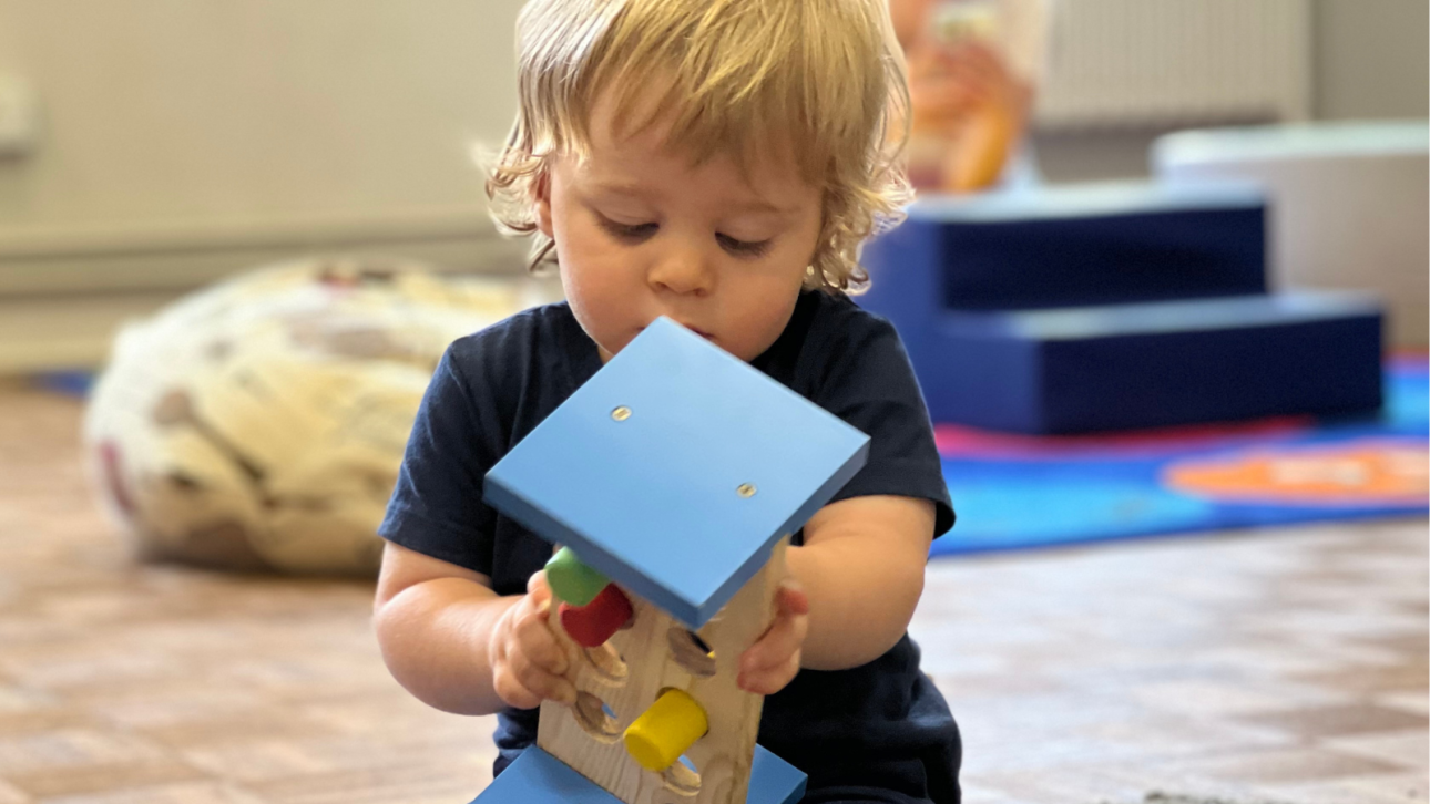 A young child playing with toys at MAP's Stay & Play