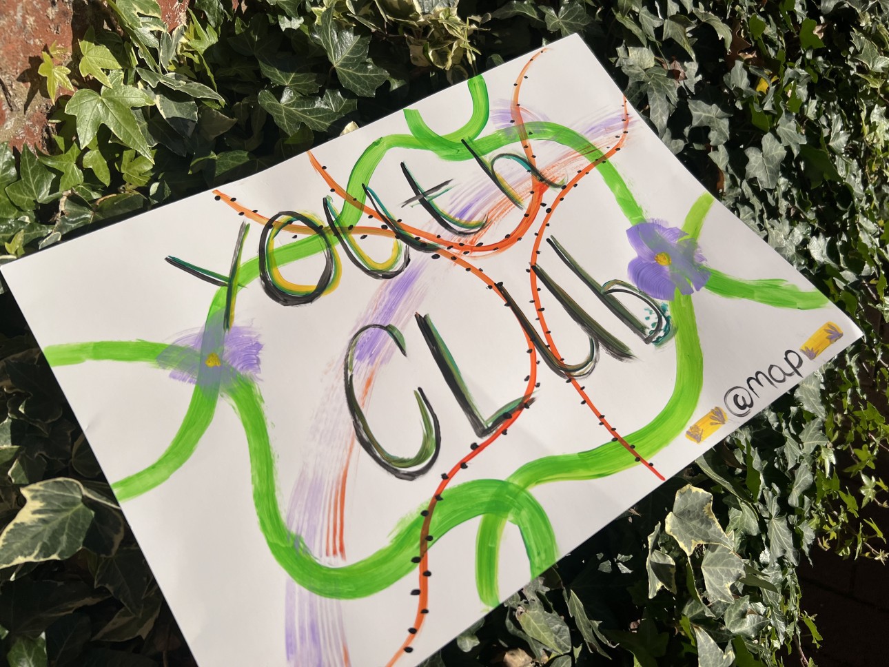 Young people's art reading 'youth club' decorated with painted flowers and vines