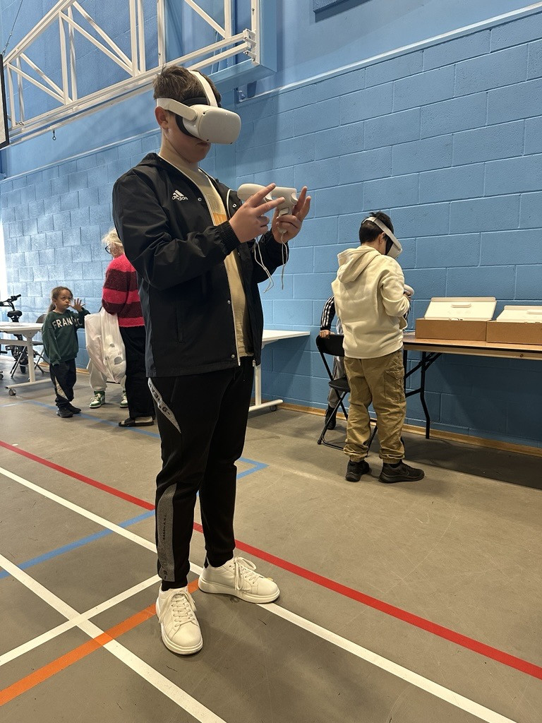 a young man playing with a virtual reality headset