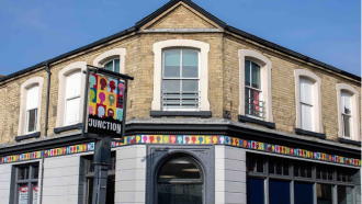 A exterior shot of The Junction in Lowestoft, a corner building, formerly a pub, on a sunny day