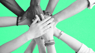 Ten hands placed on top of each other in a circle