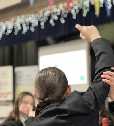 A young person raising their hand