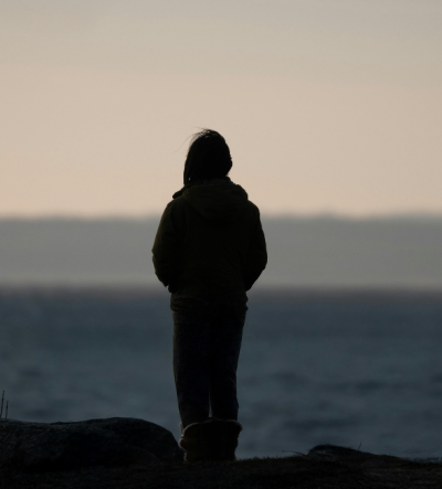 The silhouette of a young person