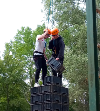 Two young people climbing at an outdoor activity centre