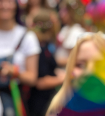 Unfocused image of crowd with Pride flag