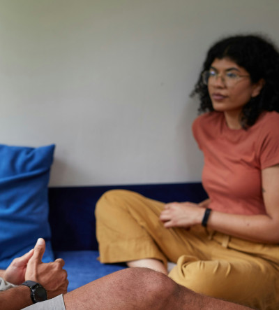 Two people sat on the floor talking