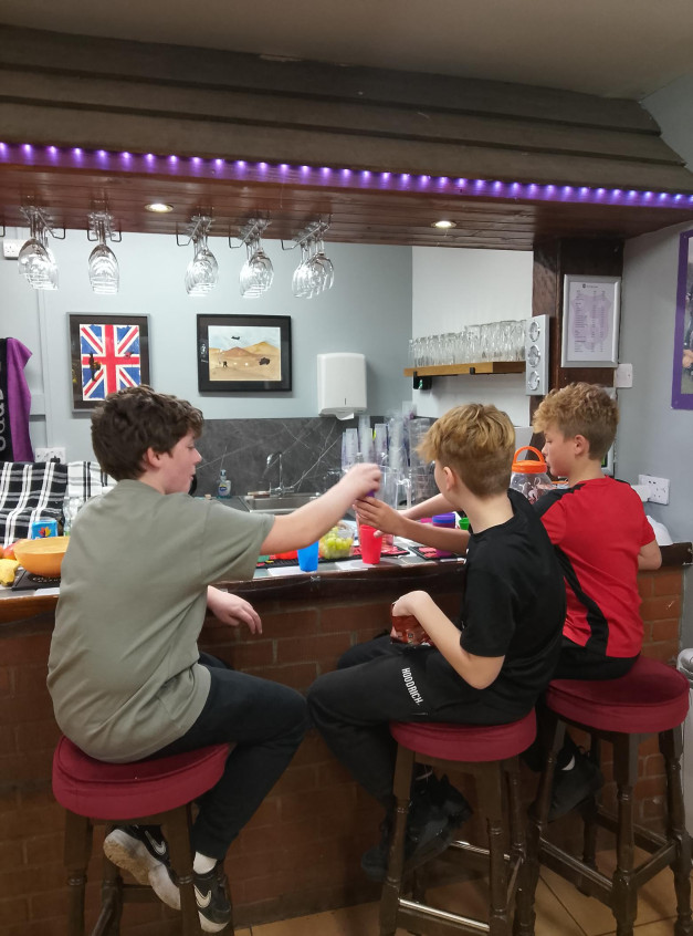 a group of young people drinking soft drinks at a bar