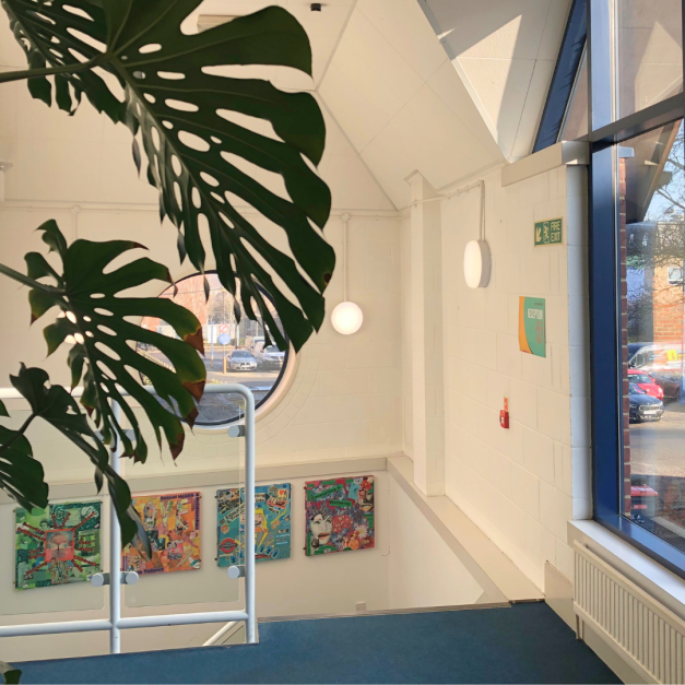Sunny stairwell with paintings on the wall
