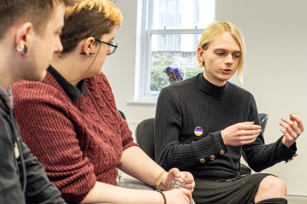 Young people sat in a circle talking