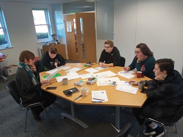 Young people working around a big table