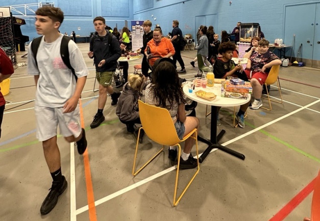 Young people at the Marina centre playing games - board games and video games - in a large sports hall