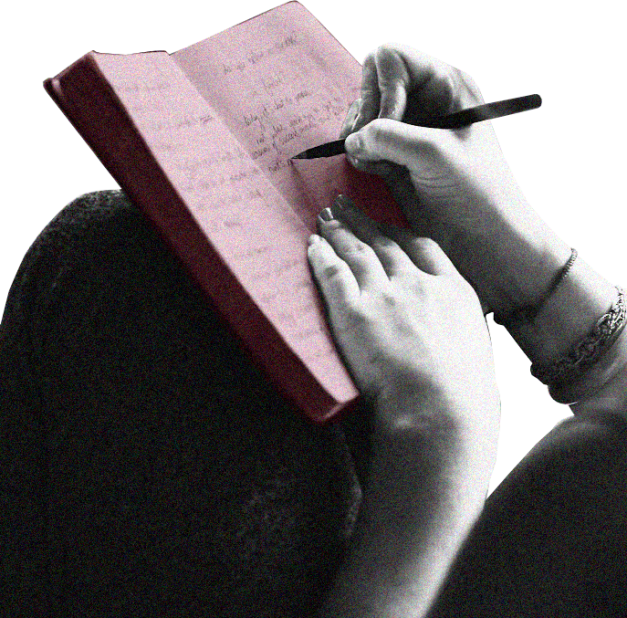 a girl's hand writing in a pink journal
