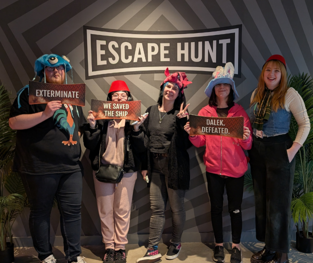 Young people celebrating their victory at a local escape room