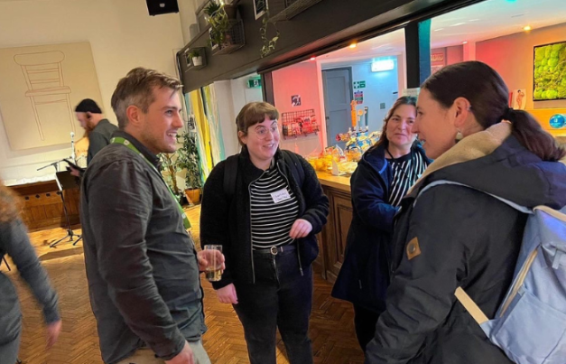 A youth worker talking to supporters by the bar at Norwich Arts Centre