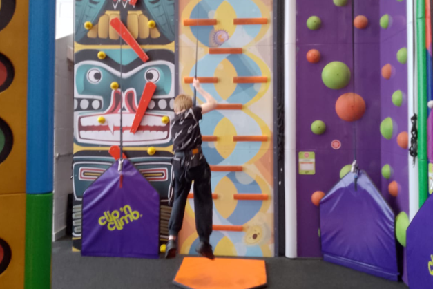 Young person on a cliumbing wall